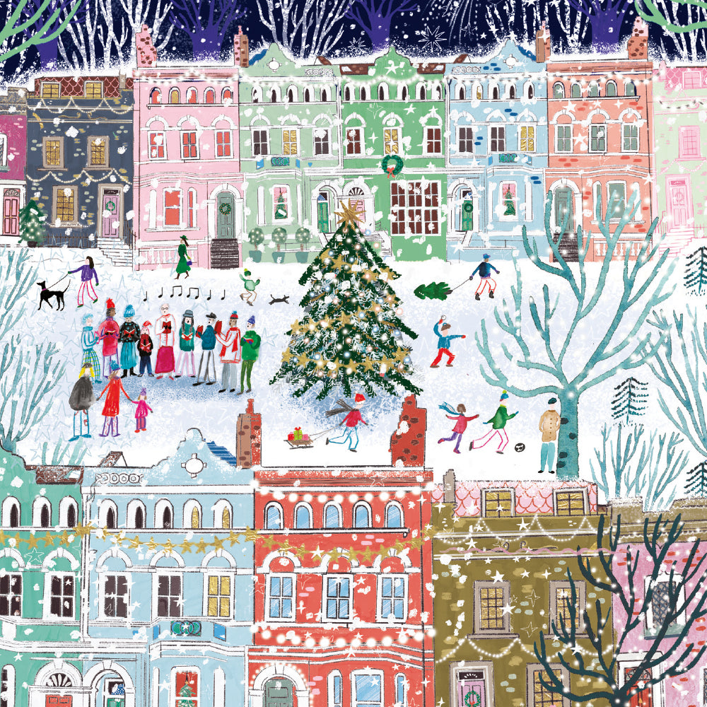 Illustration of colourful Victorian-style townhouses in pastel shades, with snow-covered ground and rooftops. A large decorated Christmas tree stands in the centre while people gather, sing carols, play in the snow, and pull a sled.